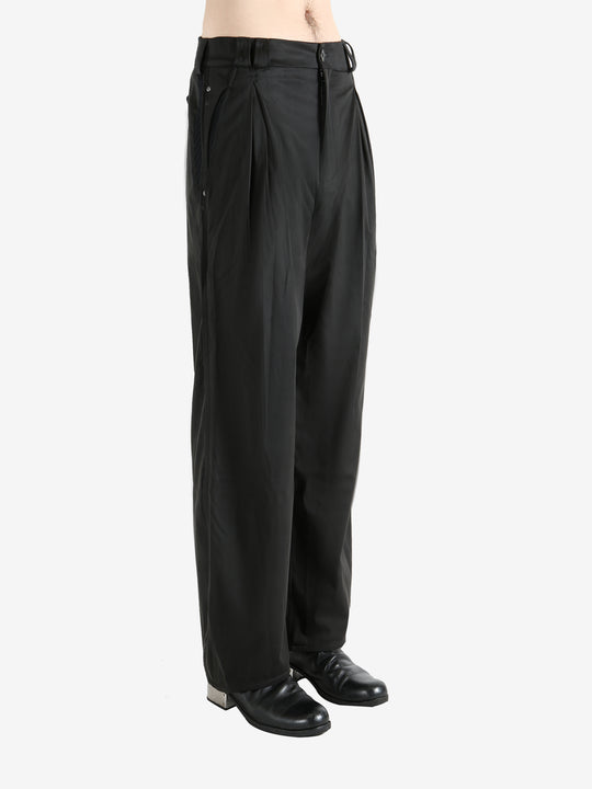 Black pants worn by a person, showing the pants' fit