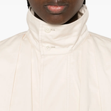 Close up of white jackets-coats, showing texture of the cotton fabric