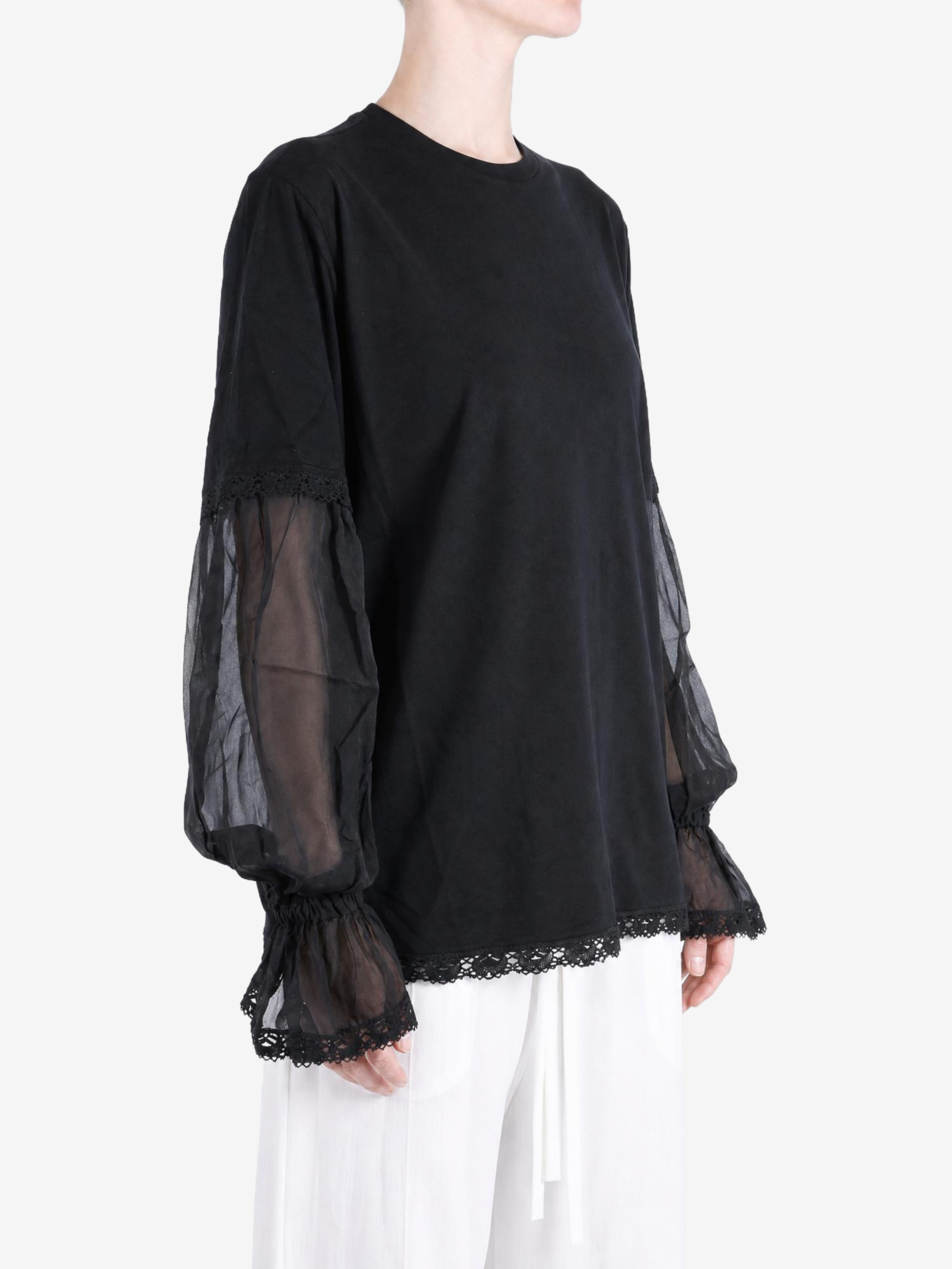 Black t-shirt worn by a person, showing the t-shirt fit