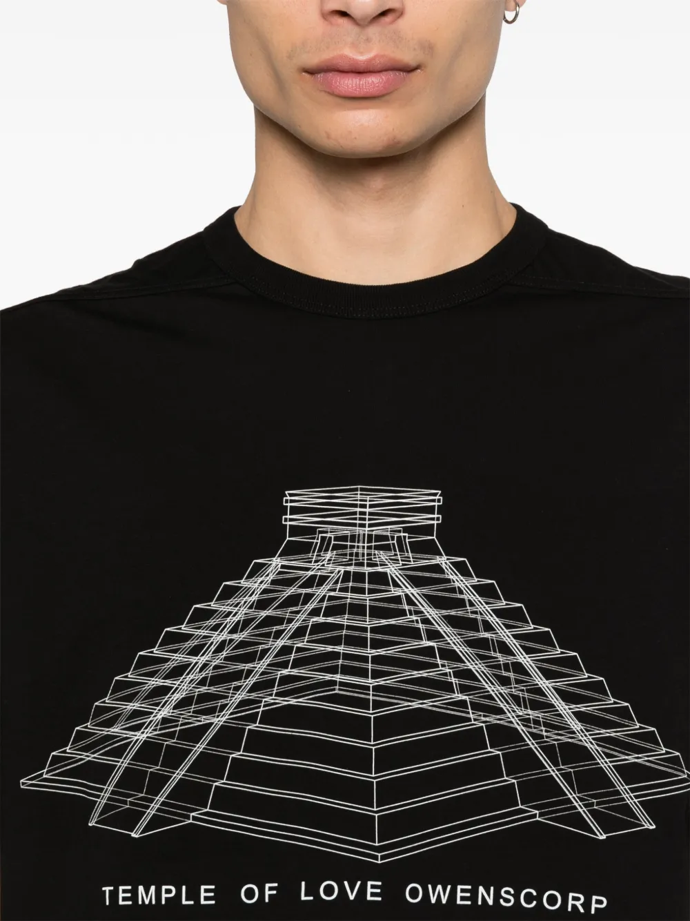 Close up of black t-shirt, showing texture of the orangic cotton fabric