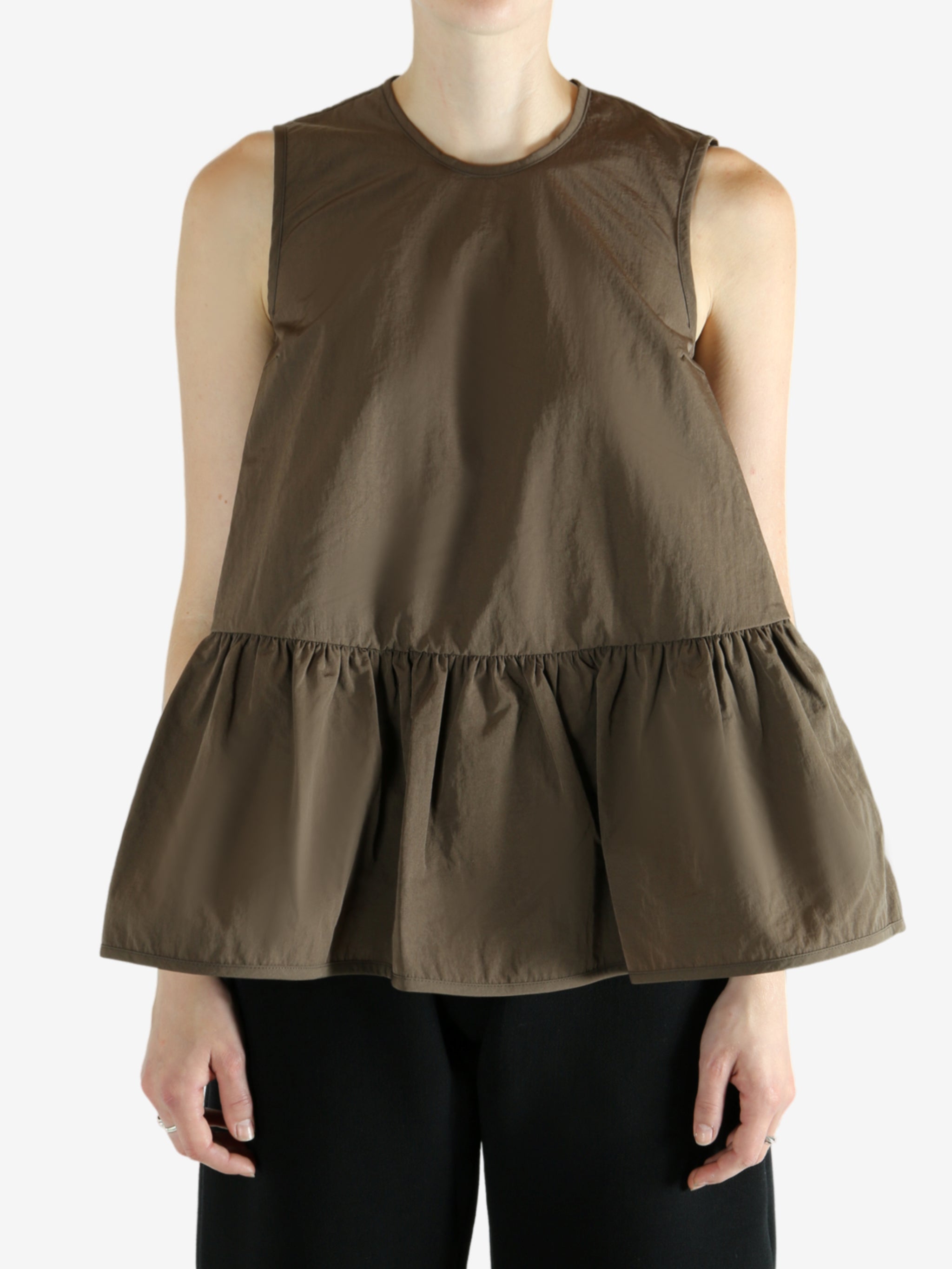 Brown top worn by a person, showing the top's fit