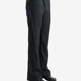 Black pants worn by a person, showing the pants' fit
