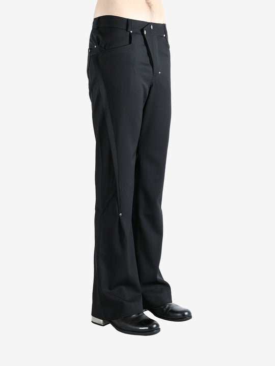 Black pants worn by a person, showing the pants' fit
