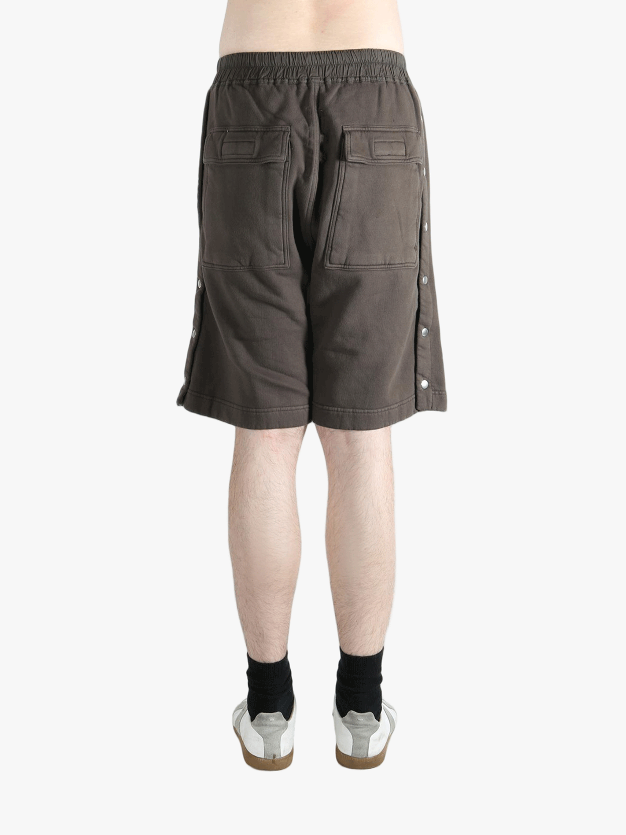 Brown shorts worn by a person, showing the shorts fit