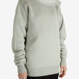 Green knitwear worn by a person, showing the knitwear fit