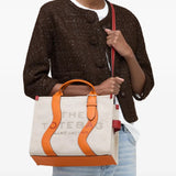 Tan bag worn by a person, showing the bag's fit