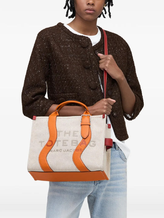 Tan bag worn by a person, showing the bag's fit