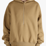 Brown hoodie worn by a person, showing the hoodie's fit