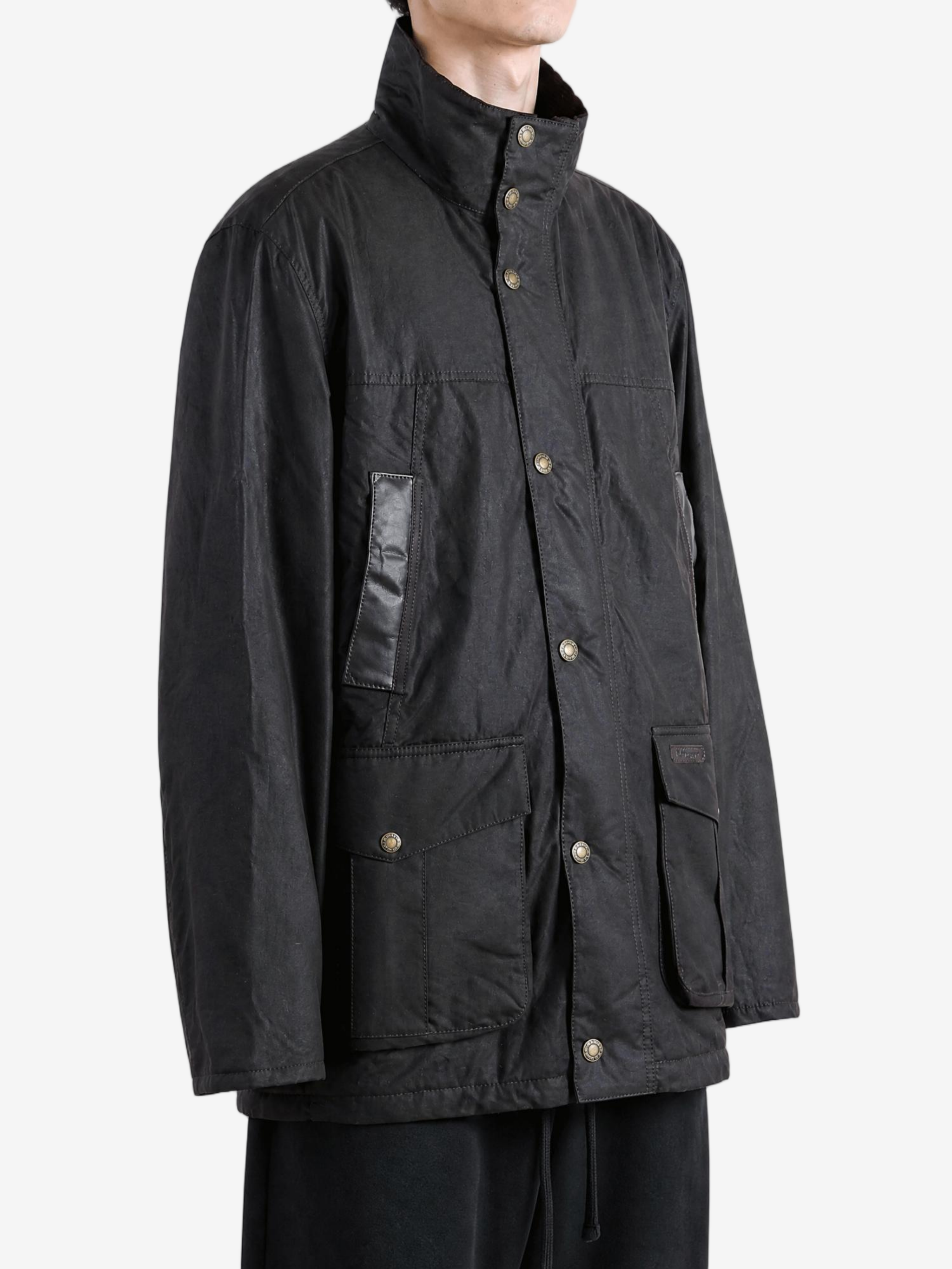 Black jacket worn by a person, showing the jacket fit