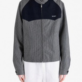 Grey jacket worn by a person, showing the jacket fit