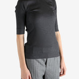 Grey tops worn by a person, showing the tops fit