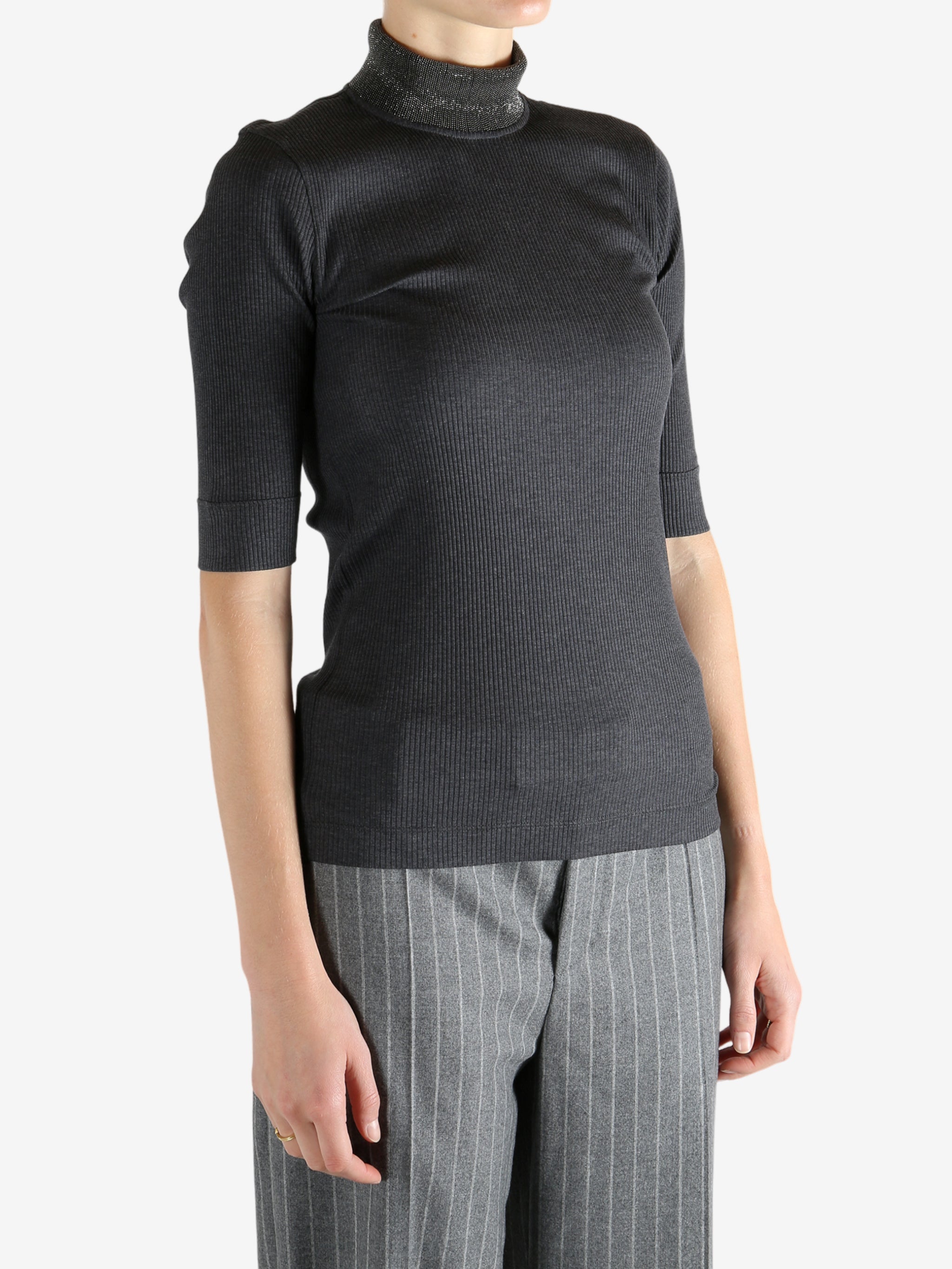 Grey tops worn by a person, showing the tops fit