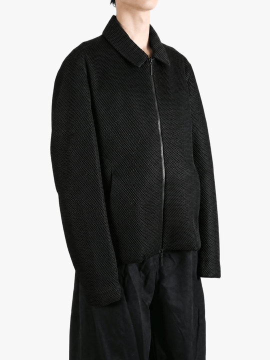 Black jacket worn by a person, showing the jacket fit