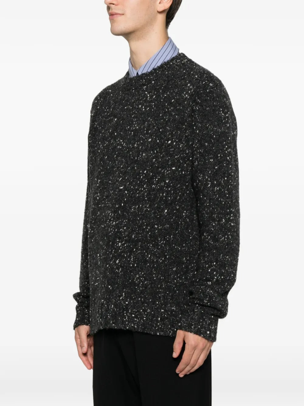 Black sweater worn by a person, showing the sweater fit