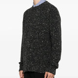Black sweater worn by a person, showing the sweater fit