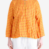 Orange shirt worn by a person, showing the shirt fit