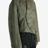 Green jacket worn by a person, showing the jacket's fit