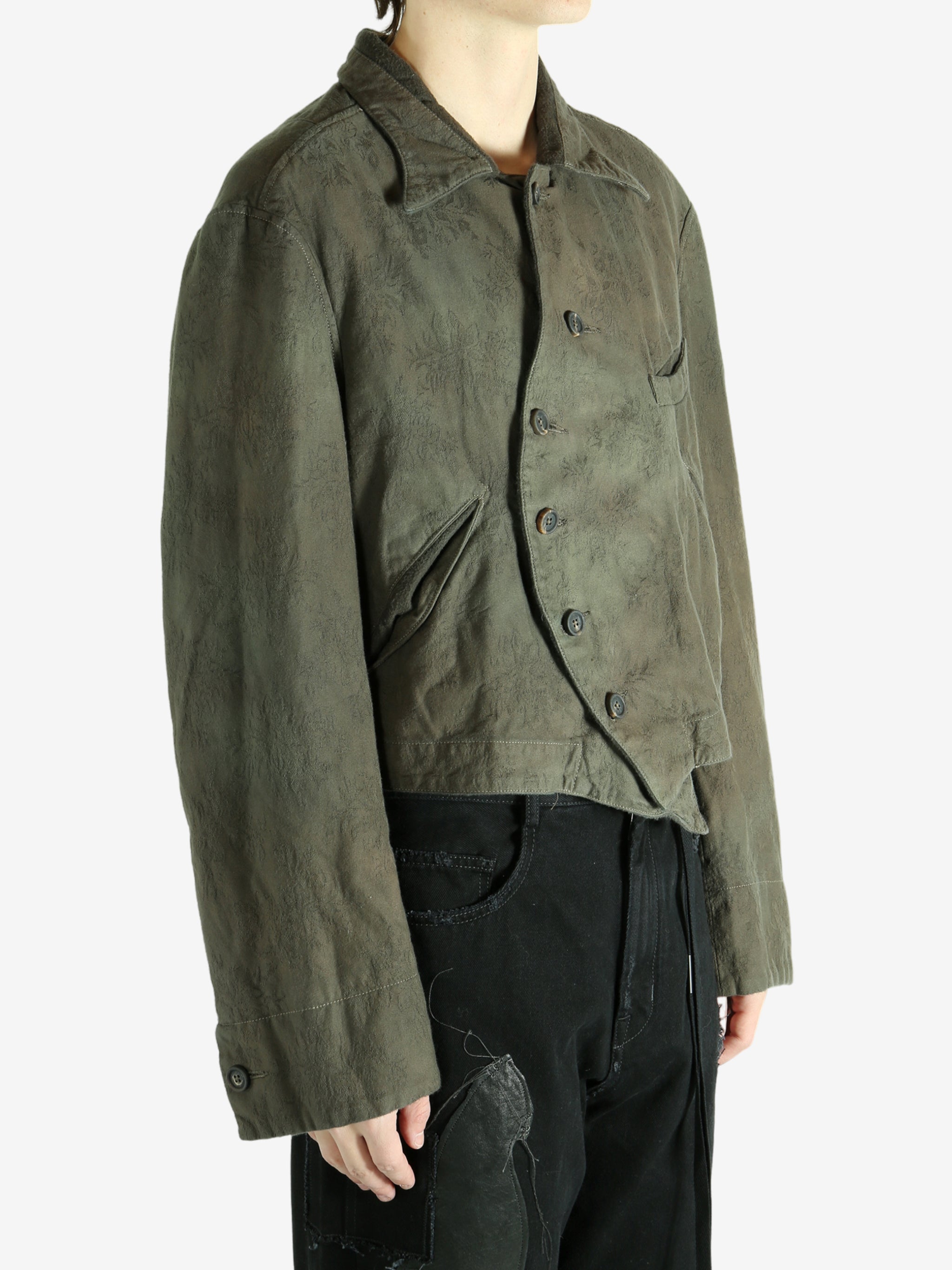 Green jacket worn by a person, showing the jacket's fit