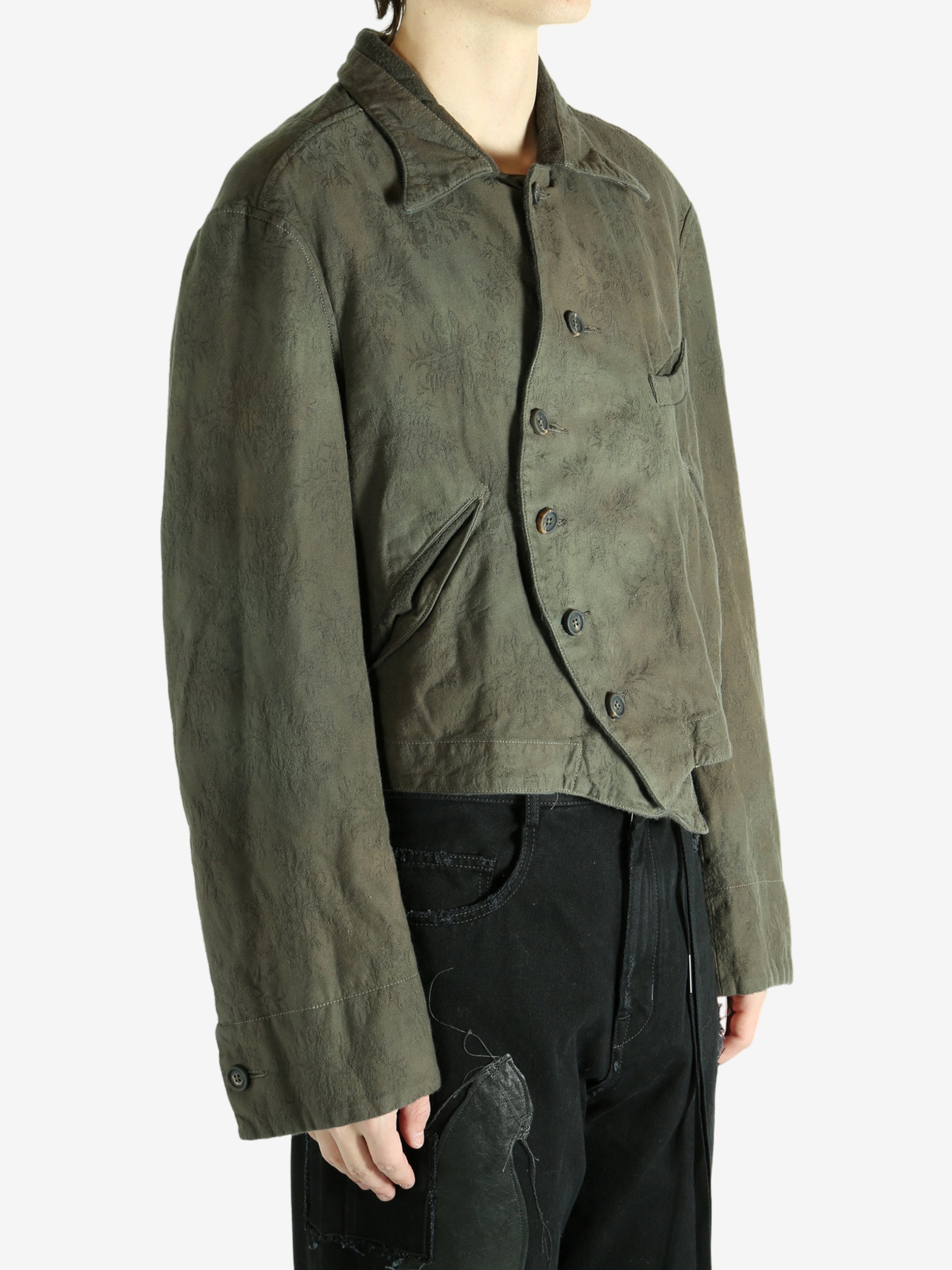 Green jacket worn by a person, showing the jacket's fit