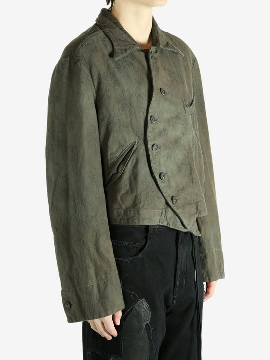 Green jacket worn by a person, showing the jacket's fit