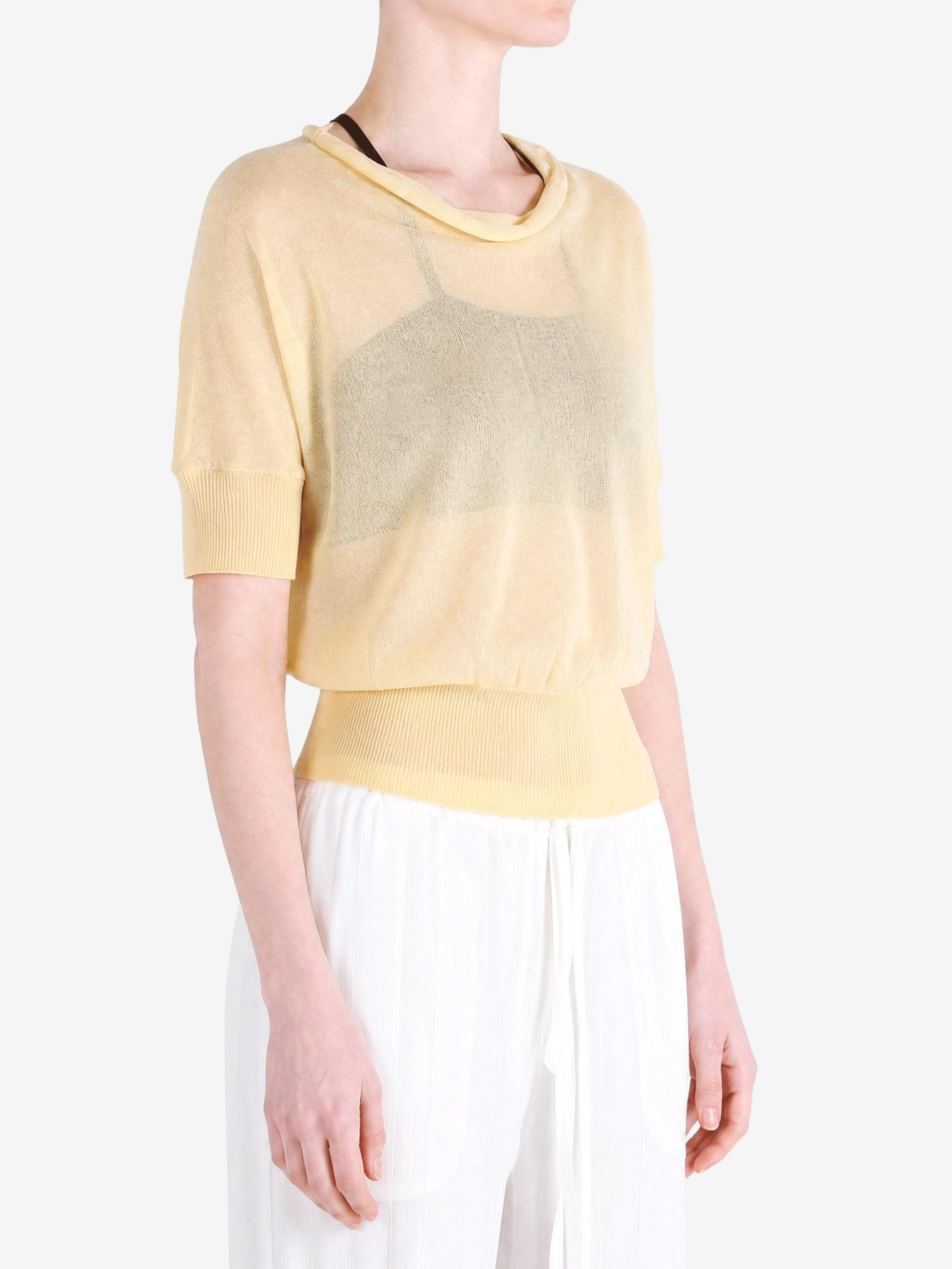 Yellow knitwear worn by a person, showing the knitwear fit