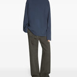 Blue sneakers worn by a person, showing the sneakers' fit