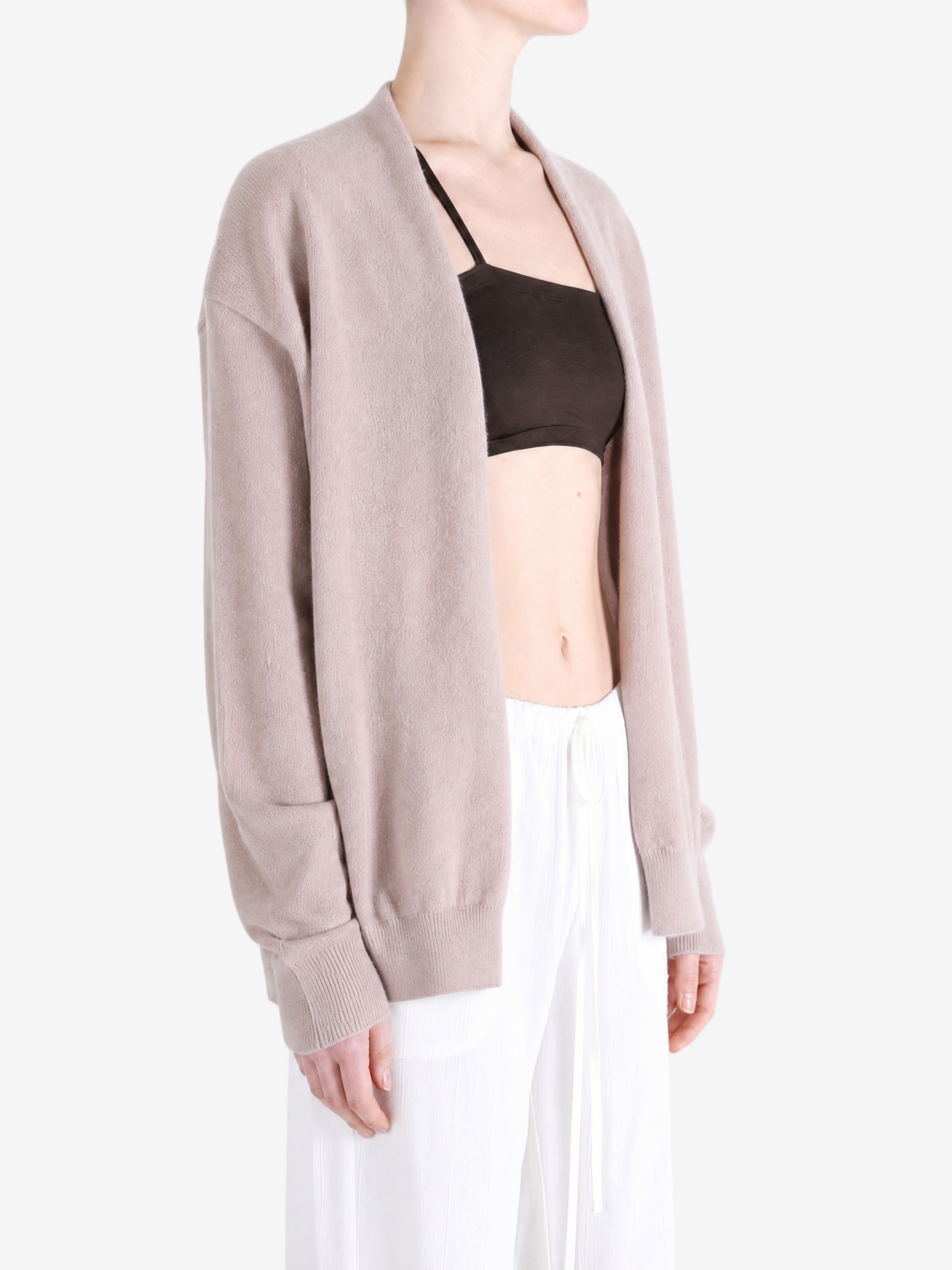 Tan knitwear worn by a person, showing the knitwear fit