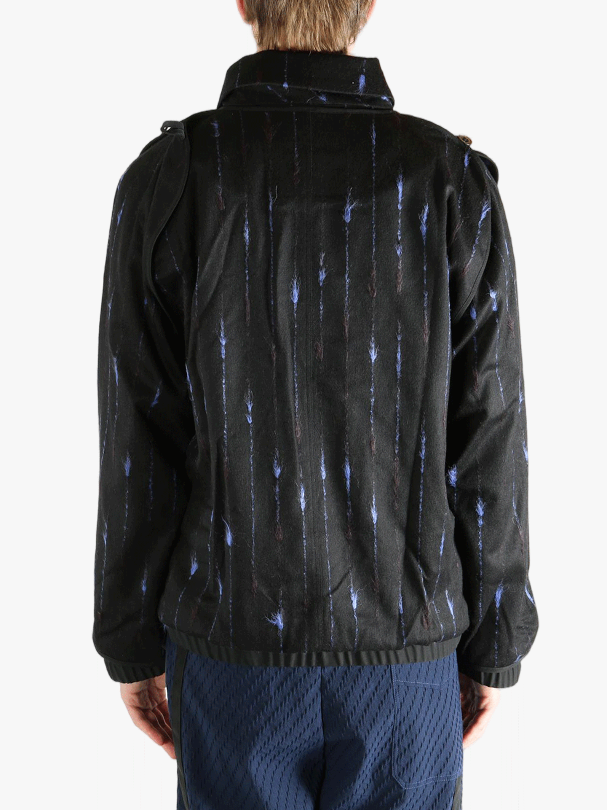 Black jacket worn by a person, showing the jacket's fit