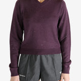 Purple knitwear worn by a person, showing the knitwear fit