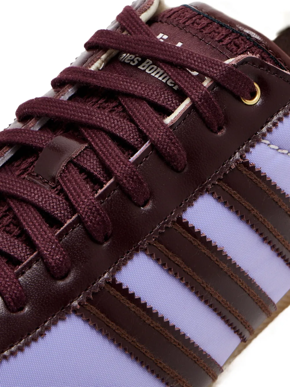 Close up of purple sneakers, showing texture of the textile and rubber fabric