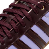 Close up of purple sneakers, showing texture of the textile and rubber fabric