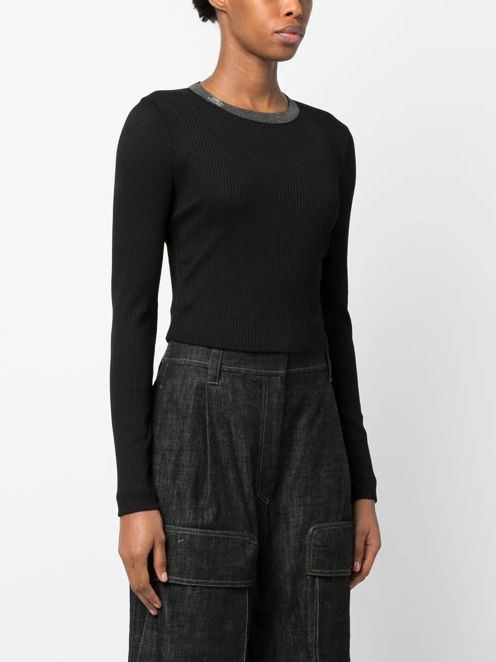 Black tops worn by a person, showing the tops fit