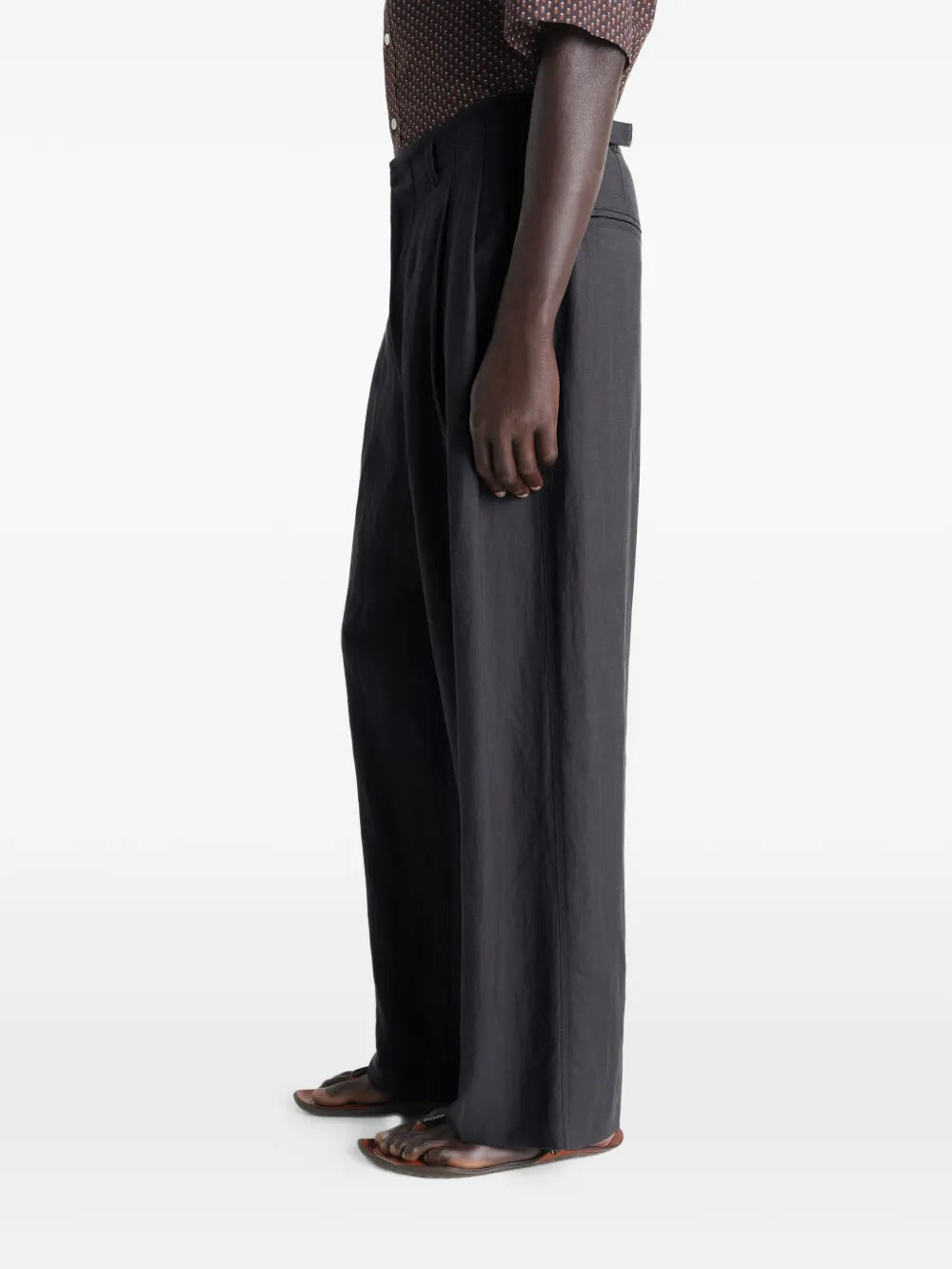 Black pants worn by a person, showing the pants fit