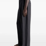 Black pants worn by a person, showing the pants fit