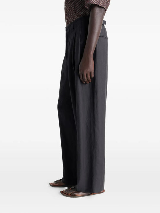 Black pants worn by a person, showing the pants fit