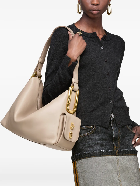 Beige bag carried by a person, showing the bag fit