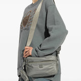 Grey bags worn by a person, showing the bags' fit