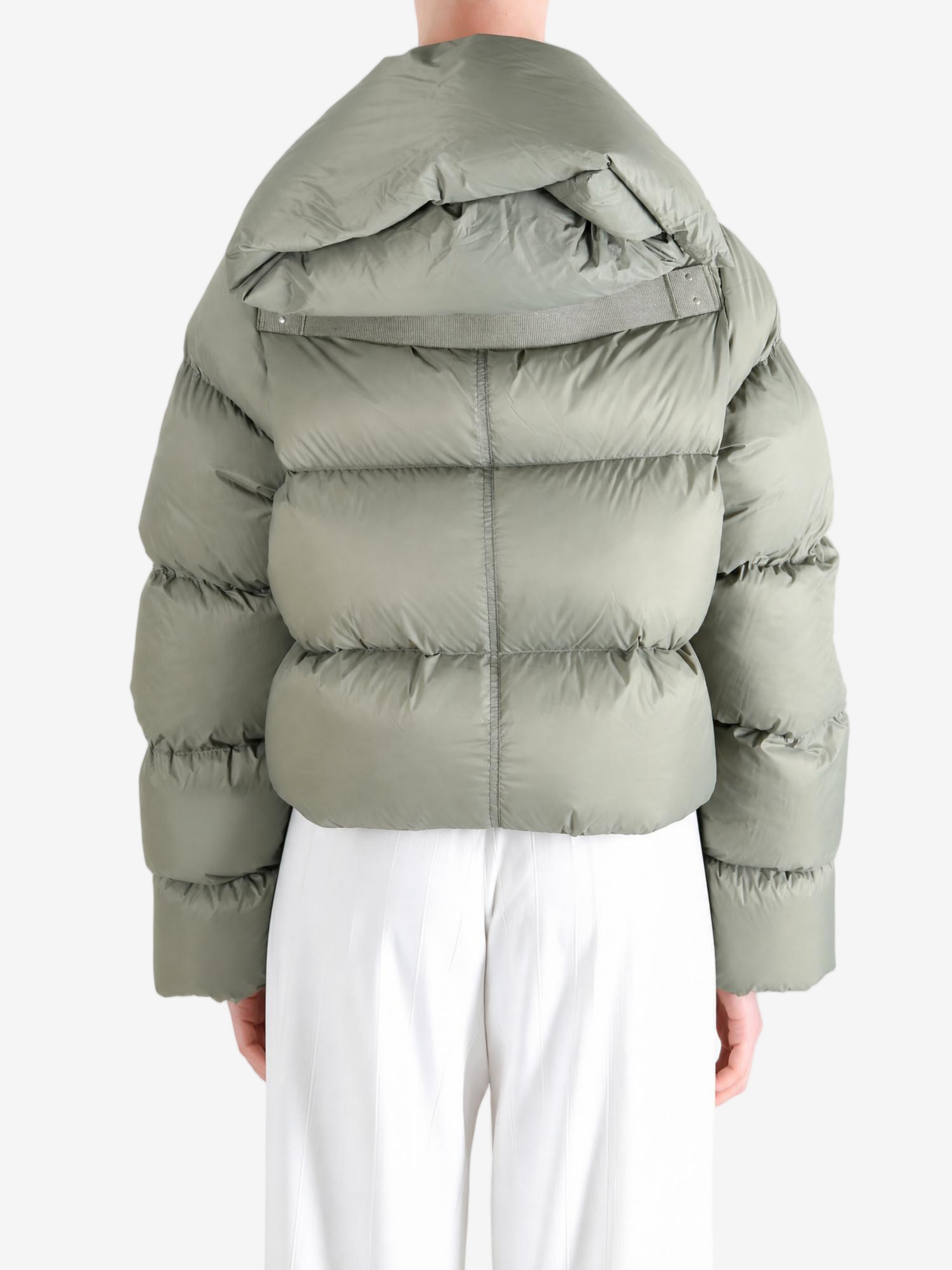 Green jacket worn by a person, showing the jacket fit