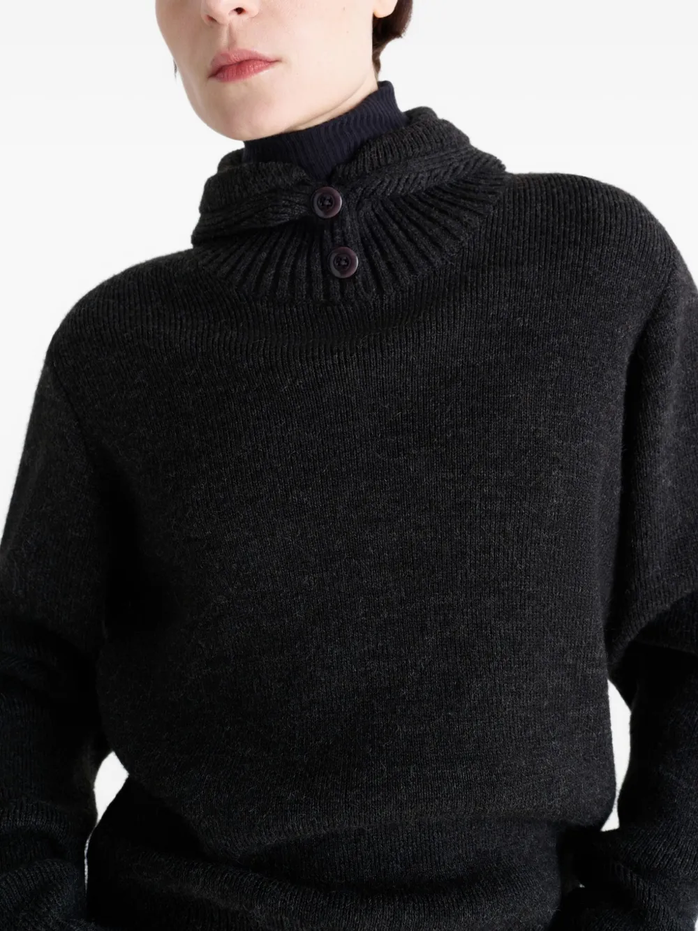 Close up of black sweater,showing texture of the acrylic fabric.