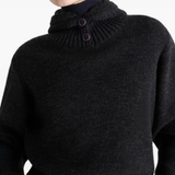 Close up of black sweater,showing texture of the acrylic fabric.