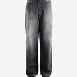 Black jeans worn by a person, showing the jeans' fit