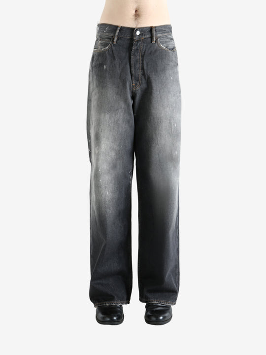 Black jeans worn by a person, showing the jeans' fit