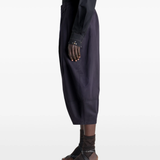 Navy pants worn by a person, showing the pants's fit