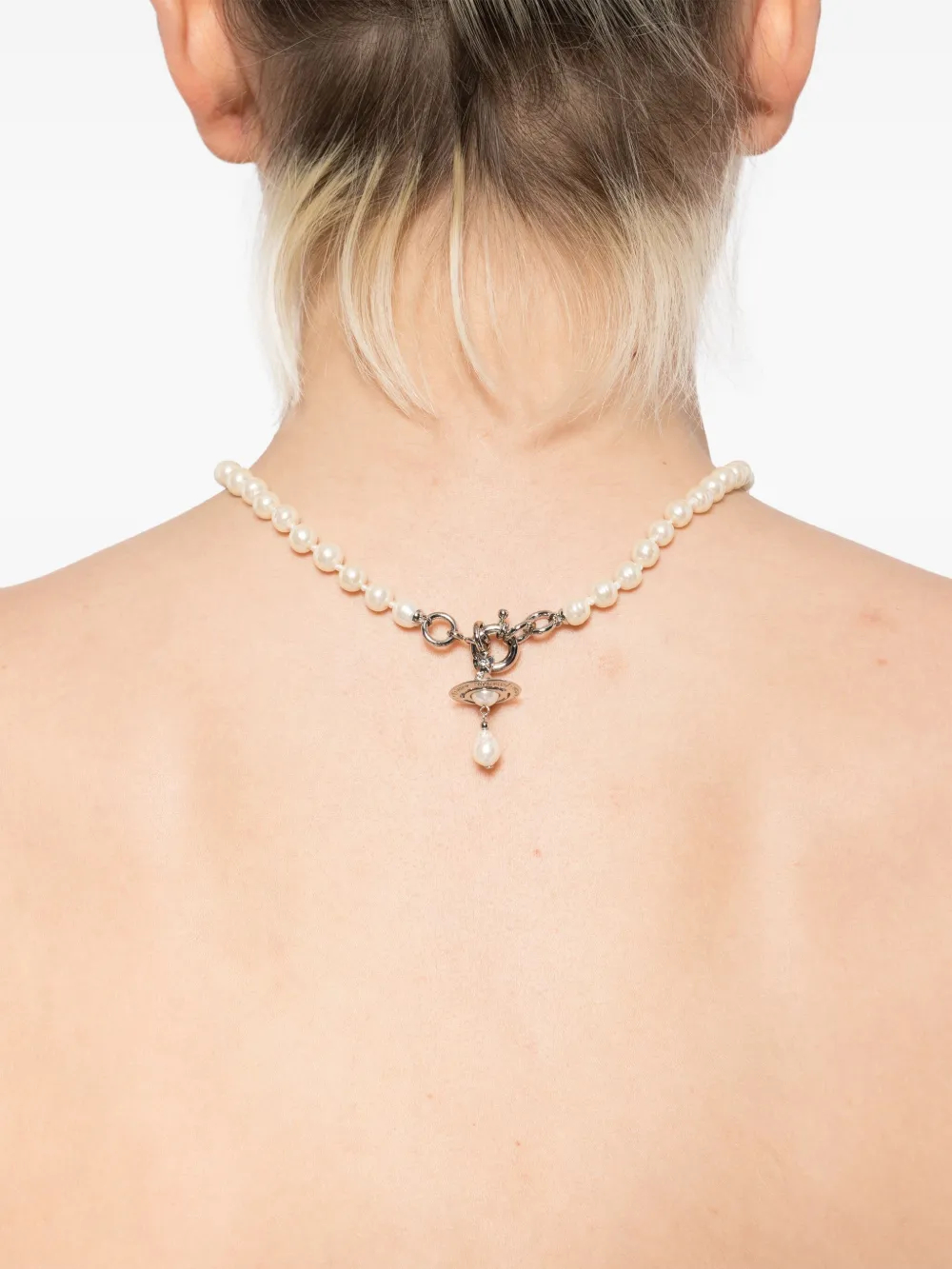 White necklace worn by a person, showing the necklace's fit