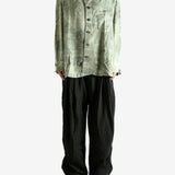 Green shirt worn by a person, showing the shirt's fit