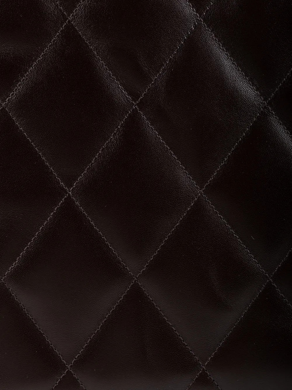 Close up of Brown bag, showing texture of the 100% calf leather made fabric
