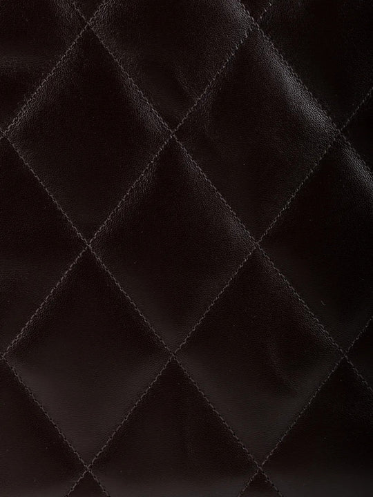 Close up of Brown bag, showing texture of the 100% calf leather made fabric