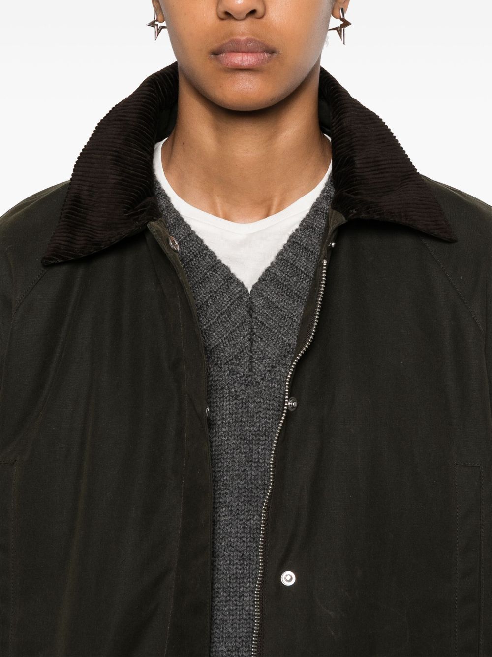 Close up of green jacket, showing texture of the cotton fabric