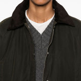 Close up of green jacket, showing texture of the cotton fabric