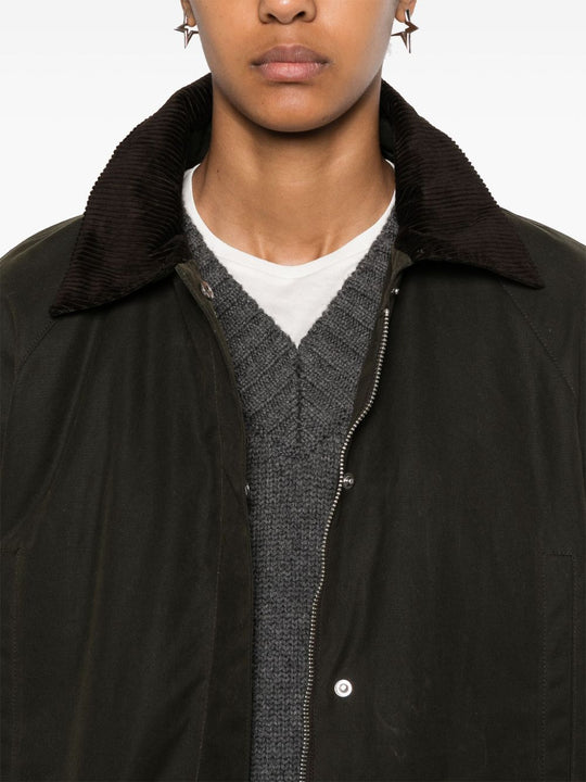 Close up of green jacket, showing texture of the cotton fabric